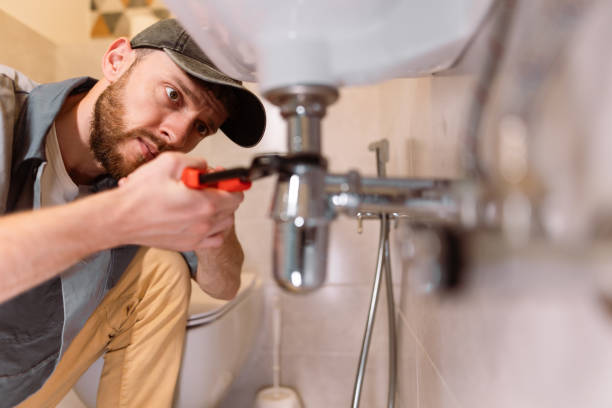 Plumber fixing pipes